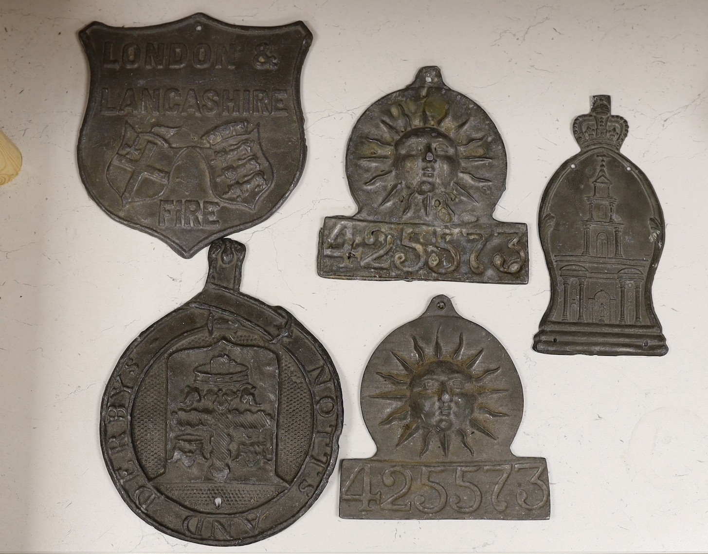 Five lead firemarks, the largest 25cm high